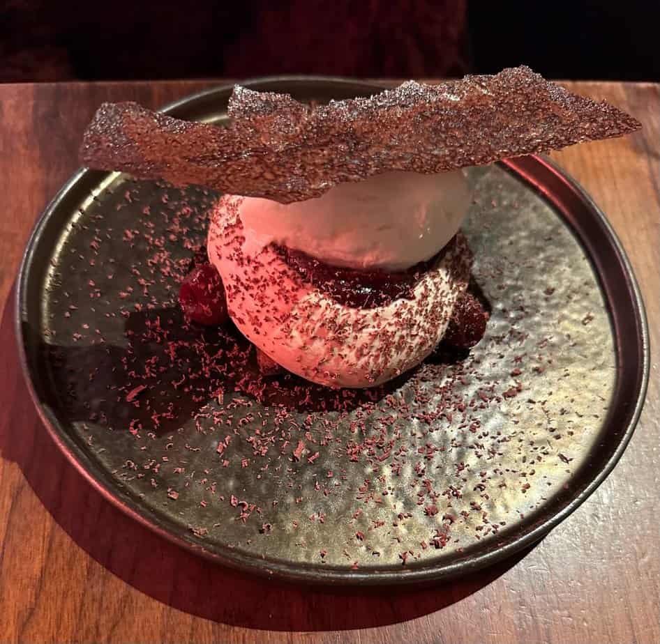 Image of cherry dessert served at Fallow, the sustainable restaurant in London's West End. The dish features locally sourced ingredients and showcases the restaurant's commitment to eco-friendly dining