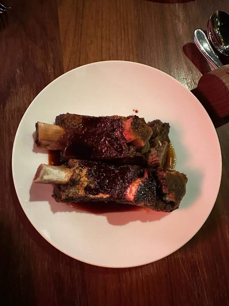 Image of Short Ribs served at Fallow, the sustainable restaurant in London's West End. The dish features locally sourced ingredients and showcases the restaurant's commitment to eco-friendly dining